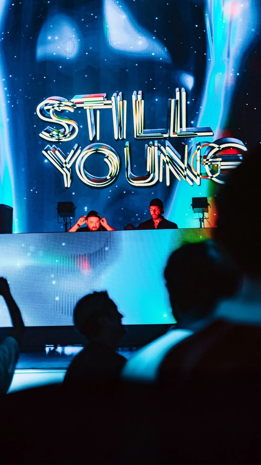 Still Young performing beneath the logotype on the LED wall