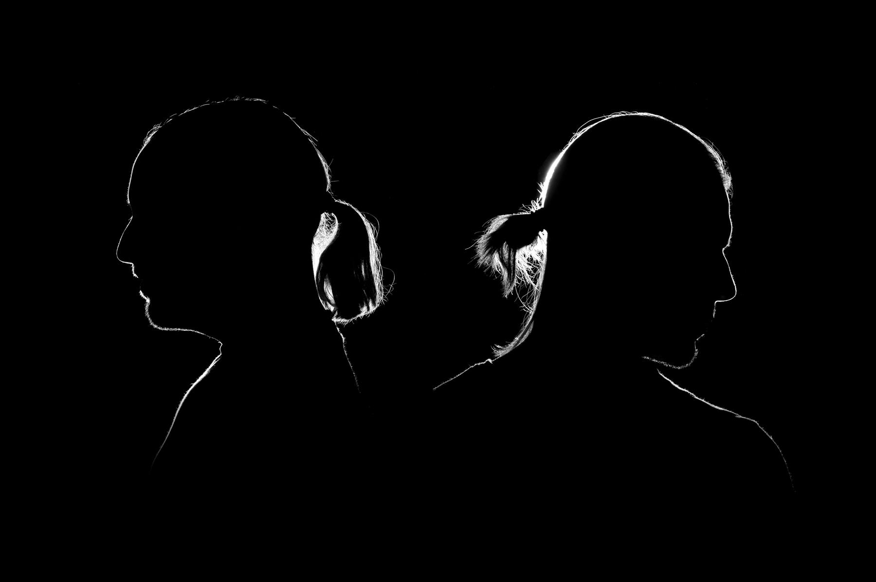 Still Young, back-to-back silhouette portrait of the duo